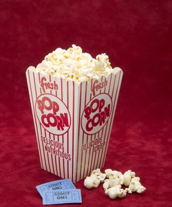 Box of movie popcorn and admission tickets