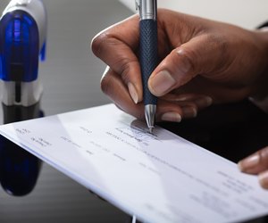 Businessperson Signing Cheque