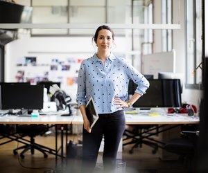 Businesswoman standing with digital tablet