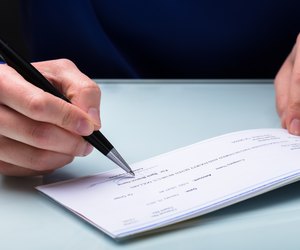 Businessperson Signing Cheque