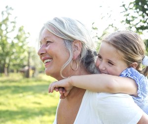 Little girl on a piggy back ride with her grandmother