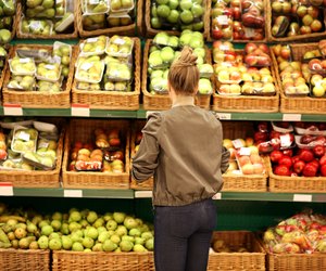 Middle-age woman buying vegetables at the market