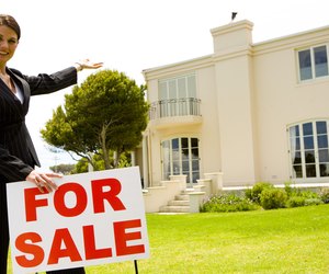 Real estate agent with house for sale