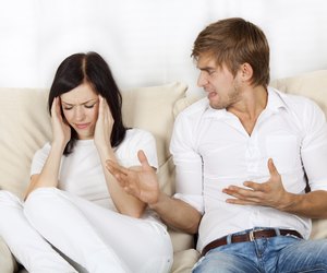 Couple sitting on couch at home
