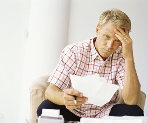 mid adult man holding bills in his hand