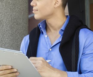Young man writing on a clipboard