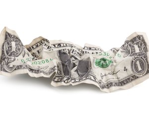 Crumpled one dollar bill in