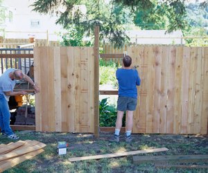 Carpenters Building a Fence