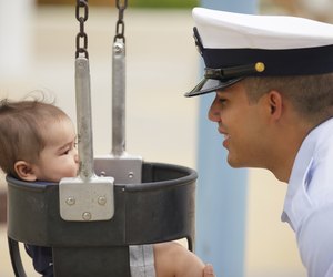 Stock image of a military man with his baby