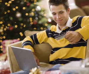 Teenage boy using laptop computer at Christmas