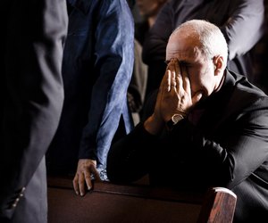 Man praying in a pew