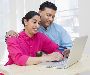 Woman and man with laptop and credit card