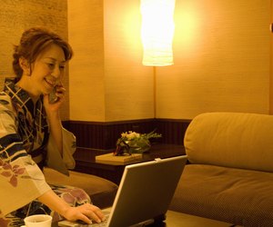 Woman talking on a mobile phone and using a laptop