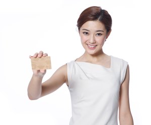 Young business lady holding credit card