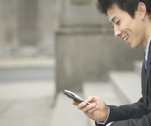 Mid adult businessman operating a mobile phone