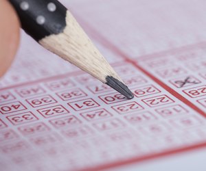 Person Marking Number On Lottery Ticket