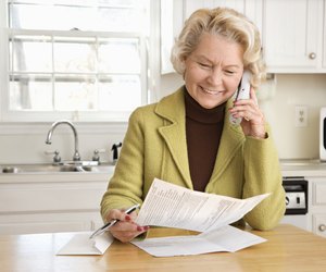 Senior woman smiling as she talks on cordless phone