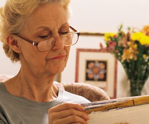 Mature woman sorting mail or coupons