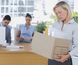 Sad businesswoman leaving office after being let go