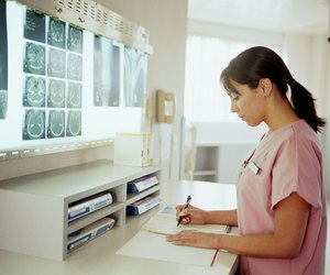 Nurse looking at paperwork in x-ray examination room