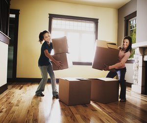 Mother and daughter stacking boxes