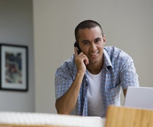 Young man talking on telephone