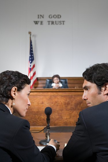A lawyer and defendant talking