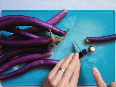 Closeup of hands dicing eggplants