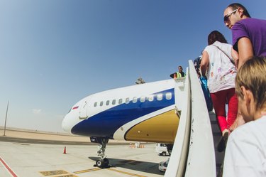 Passengers boarding airplane on tarmac