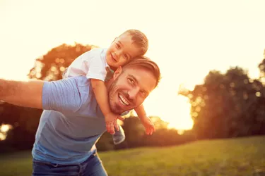 Father piggyback his son outside