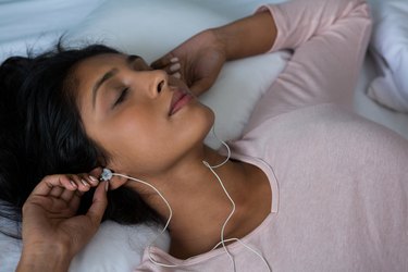 Woman sleeping while listening to music