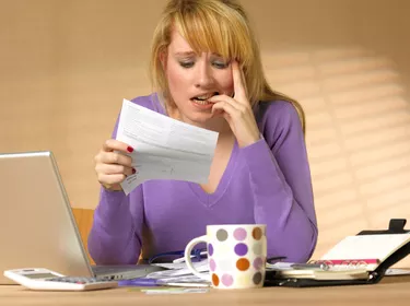 perplexed young woman with paperwork
