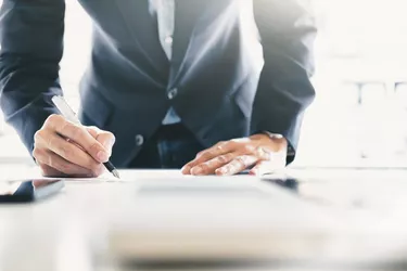 Businessman signing contract making a deal.