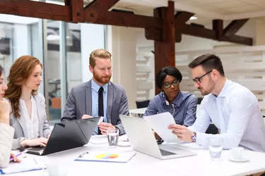 Business people discussing strategy with a financial analyst