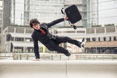 How Does Switching Jobs Affect My Wage Garnishment?Business man with suitcase jumping over urban obstacles