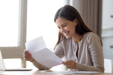 Happy excited woman reading letter with good news