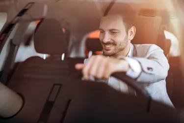 Handsome businessman driving car