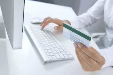 A woman shopping online using her MasterCard