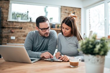Couple doing finances at home.
