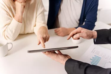 Helpful real estate agent working with aging couple of clients