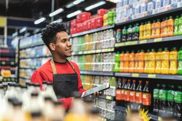 Businessman checking inventory in a digital tablet at a supermarket