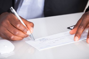 Human Hand Writing On Cheque