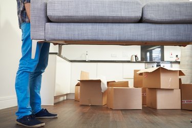 How to Evict a Roommate Not on the Lease in GeorgiaMan Carrying Sofa As He Moves Into New Home
