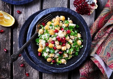 chickpea salad with couscous, parsley, olive oil and pomegranate