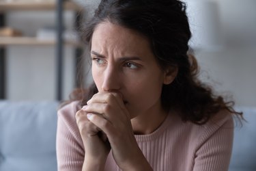 Frustrated stressed young woman thinking of difficult decision.