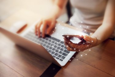 Woman hand using mobile phone and laptop, Worldwide connection technology interface.