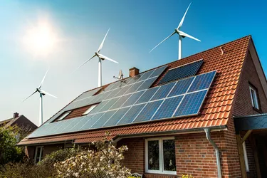 Solar panel on a roof and wind turbins arround