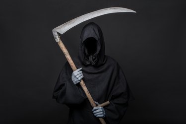 Halloween image of the death reaper on a black background