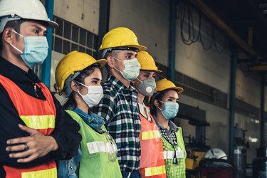 Workers with face mask protect from outbreak of Corona Virus Disease 2019.