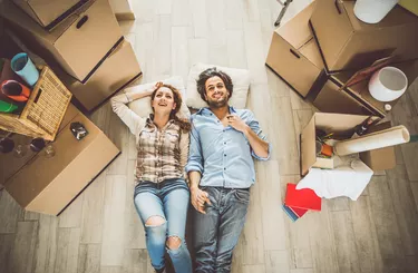 Young couple moving in into new apartment